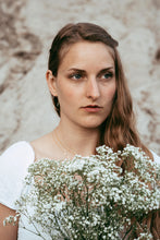 Load image into Gallery viewer, Gold Bow Earrings on model wearing white dress