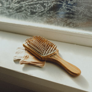 Bamboo hair brush on windowsill