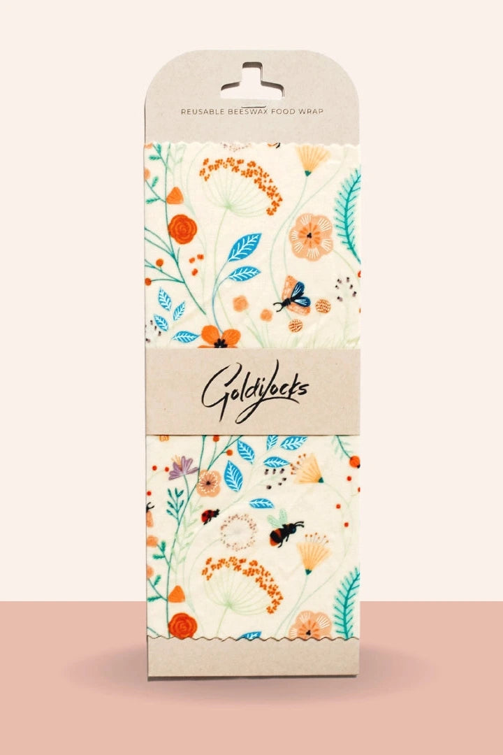 Packaging of Goldylocks food wrap with floral design on a beige background