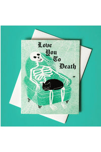 Skeleton on armchair greeting card