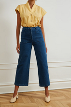 Load image into Gallery viewer, Model in yellow shirt wearing indigo high waisted jeans